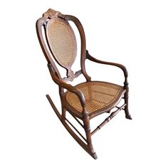 a wooden rocking chair with wicker seat and armrests on an isolated white background