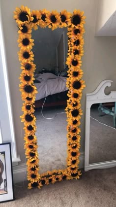 a sunflower decorated mirror sitting on the floor