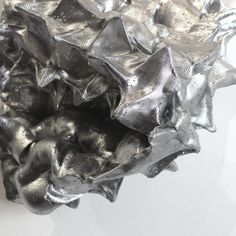 a silver object is sitting on a white surface