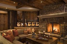 a living room filled with furniture and a fire place in front of a stone fireplace