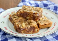 three pieces of brownies on a plate with blue and white checkered table cloth