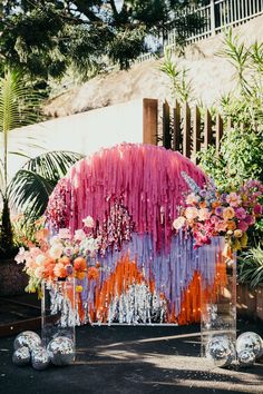 an arrangement of flowers in vases on the ground