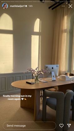 an office with two chairs and a table in front of large windows that have sunlight streaming through them