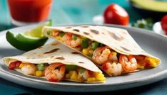 two burritos with shrimp and corn on a plate