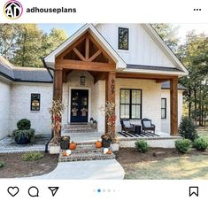 a white house with black shutters and pumpkins on the front steps in front of it