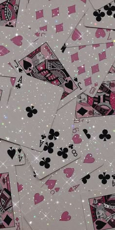 several playing cards are scattered on top of each other with sparkles and sequins