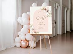 a baby shower sign in front of balloons