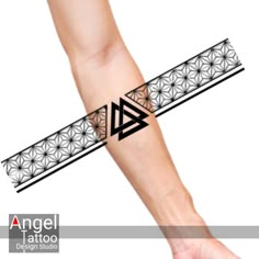 an arm tattoo with geometric designs on it