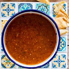 a bowl of salsa with tortilla chips on the side