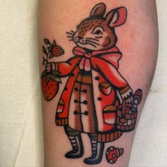 a tattoo design of a mouse holding a basket of strawberries and strawberrys on the leg