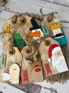 wooden tags with santa claus, snowman and reindeer on them