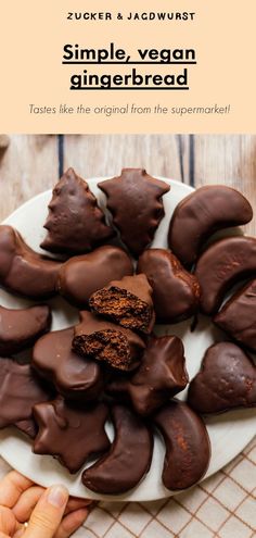 a plate full of chocolate covered cookies on top of a wooden table with text overlay that reads, simple vegan gingerbread tastes like the original from the supermarket