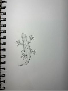 a drawing of a gecko sitting on top of a white paper