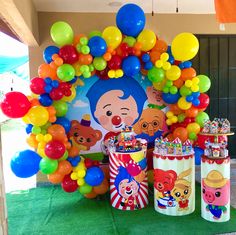 there is a birthday party with balloons and decorations on the table in front of it