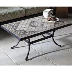 a coffee table with a glass top and some cookies on it