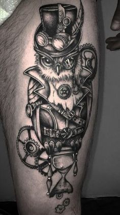 a man's thigh with an owl wearing a top hat and gears on it