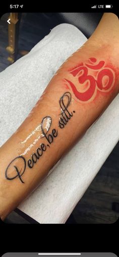 a person with a tattoo on their arm that says peace be still and an omen symbol