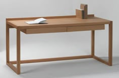 a wooden desk with a book on it