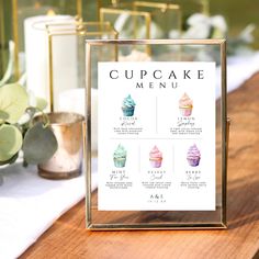 a cupcake menu sitting on top of a wooden table