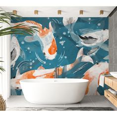 a bath tub sitting next to a wall with fish on it