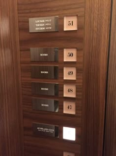 an elevator with wooden doors and metal numbers