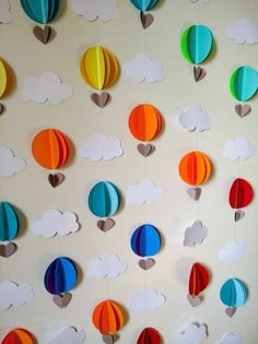 paper hot air balloons are hanging on the wall