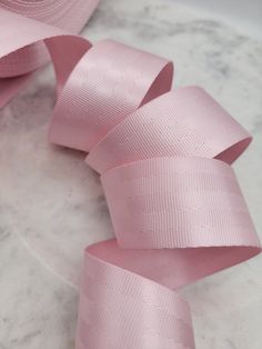 pink satin ribbon on white marble counter top