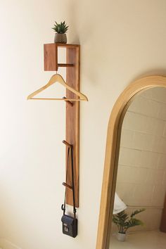 a mirror and coat rack on the wall