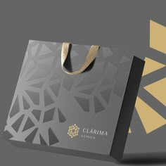 a gray and gold shopping bag with the word clarma on it's side