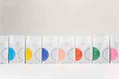 five bags with different colored circles on them sitting in front of a white wall and floor