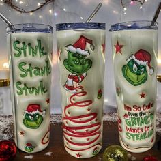 three christmas themed tumblers sitting next to each other