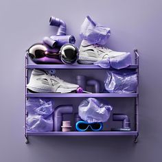 a purple shelf filled with different types of shoes and other items on top of it