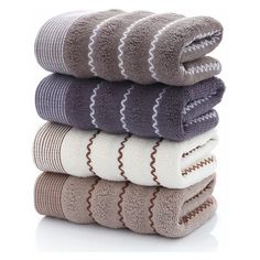 five towels stacked on top of each other in different colors and patterns, all folded together