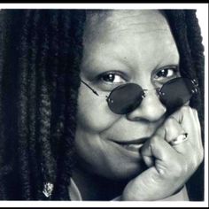 a black and white photo of a woman with dreadlocks