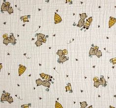 a white quilt with brown and yellow bears on it