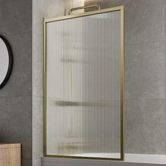 a bathroom with a mirror, sink and bathtub next to a wall mounted shower head