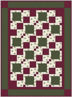 a green and red quilt with squares on it