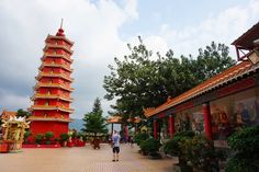 a tall red tower sitting in the middle of a courtyard