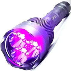 a purple flashlight is shown on a white surface