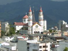 an image of a city with buildings and mountains in the background