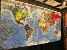 a large quilted world map hanging on the wall