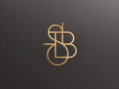 the letter b is inscribed in gold on a black background