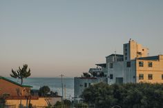 an apartment building with the ocean in the background