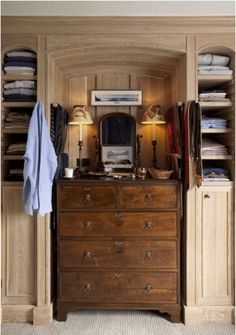 a bedroom with a dresser and closet full of clothes