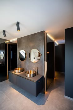 a bathroom with two sinks and mirrors on the wall