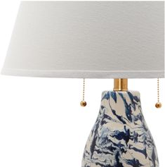 a blue and white ceramic lamp with a white shade