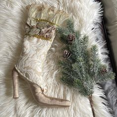 a pair of high heeled shoes sitting on top of a white fur covered floor