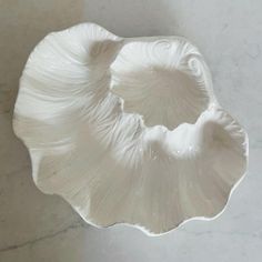 a white bowl sitting on top of a marble counter