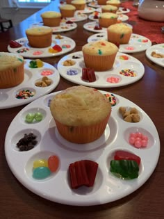 there are many cupcakes on the plates with different toppings in each one