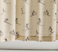 a curtain with skiers on it is hanging in front of a white counter top